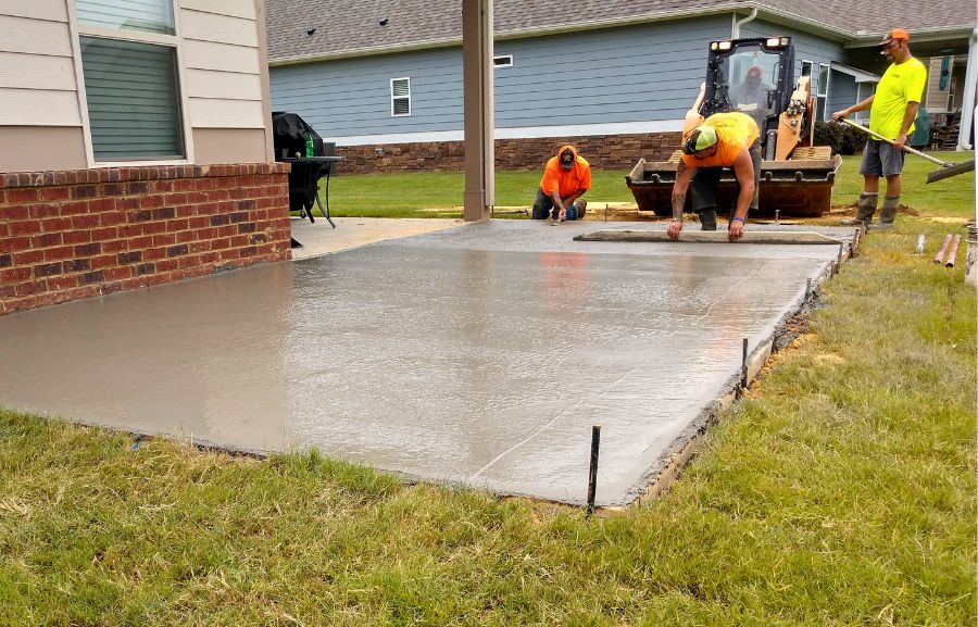 Workers Leveling Concrete for a Patio