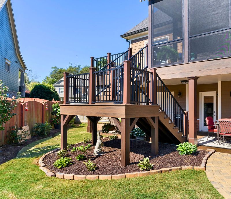 Elevated Wooden Deck With Stairs In A Backyard