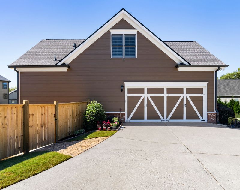 House Exterior With A Two-car Garage And Driveway